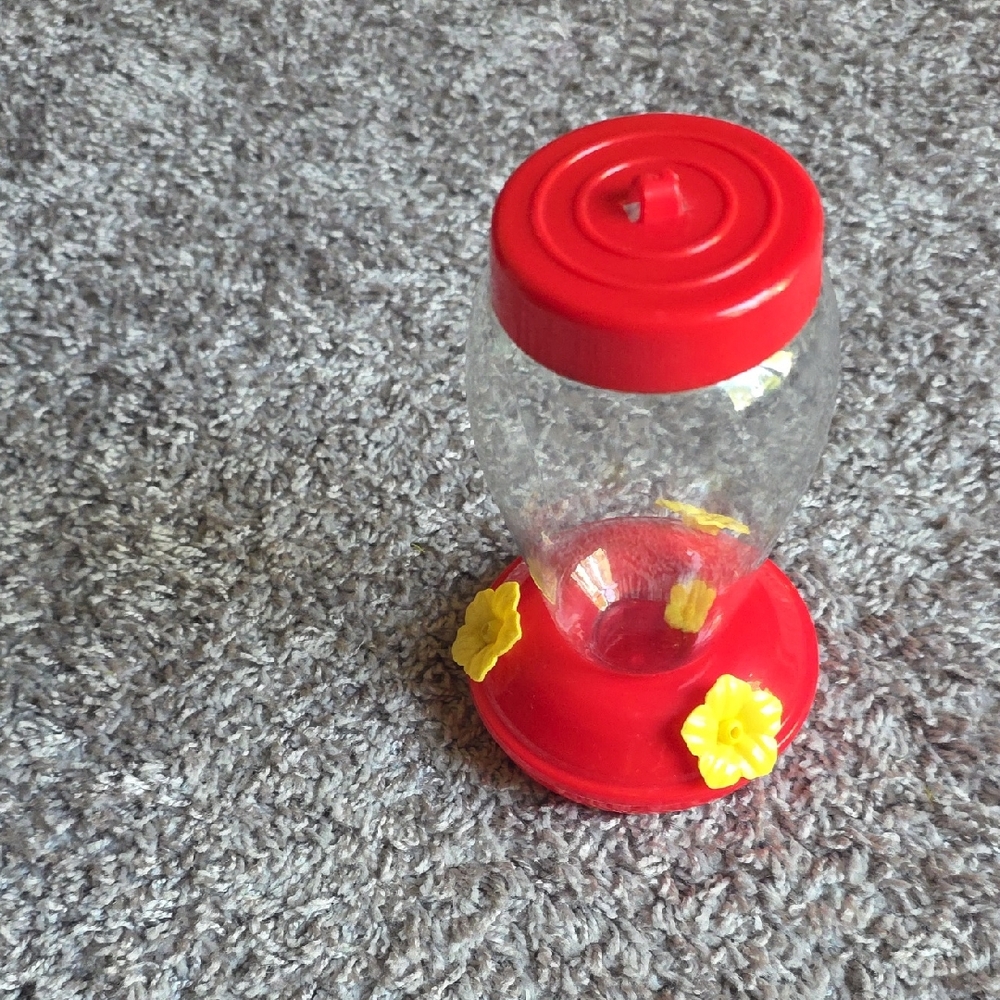 Red Plastic Hummingbird Feeder With Yellow Flowers